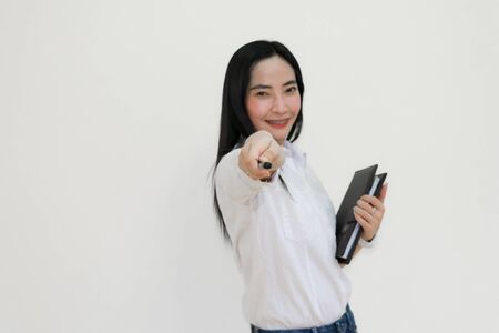 Asian young woman thinking beautiful smile put a white shirt stand of on white background.の写真素材