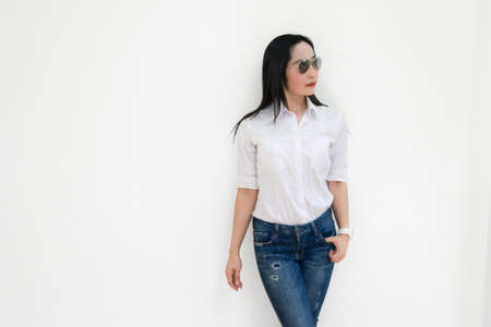Asian young woman thinking beautiful smile put a white shirt stand of on white background.の写真素材