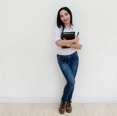 Asian young woman thinking beautiful smile put a white shirt stand of on white background.の写真素材