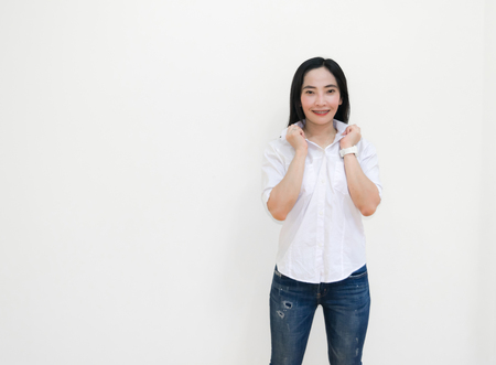Asian young woman thinking beautiful smile put a white shirt stand of on white background.の写真素材