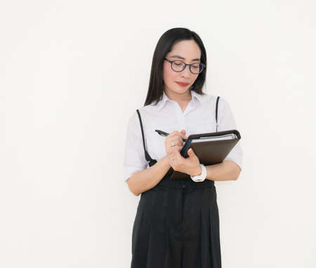 Asian young woman thinking beautiful smile put a white shirt stand of on white background.の写真素材
