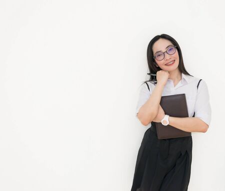 Asian young woman thinking beautiful smile put a white shirt stand of on white background.の写真素材