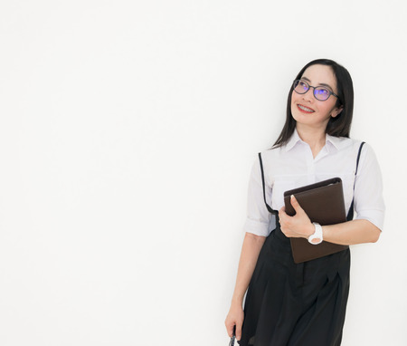 Asian young woman thinking beautiful smile put a white shirt stand of on white background.の写真素材