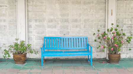Brick wall, wooden window doors and chairsの写真素材