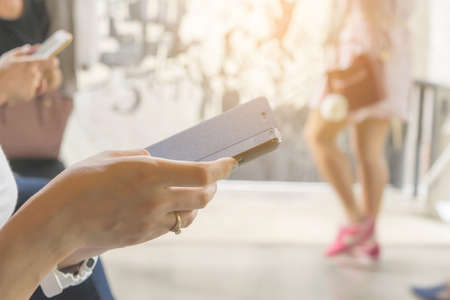 woman holding of mobile phone and smartphone.の写真素材