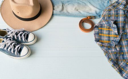 Accessories costume clothes Jeans and hats sunglasses shoes on Wooden floor background.の写真素材