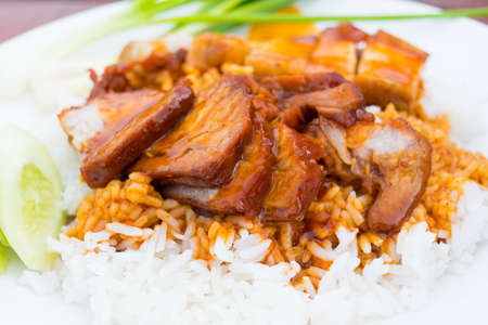 Barbecued red pork in sauce with rice on the tableの写真素材