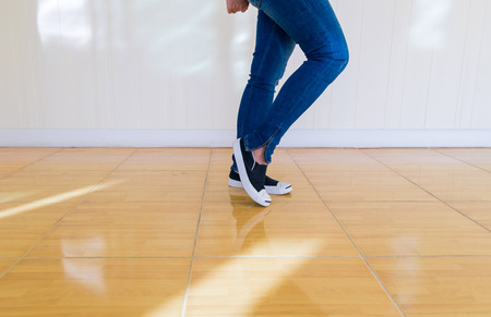 Jeans and shoes Legs standing on the floor.の写真素材