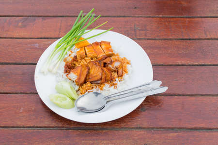 Barbecued red pork in sauce with rice on the tableの写真素材