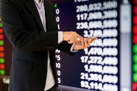 Businessmen hold a smartphone financial information stock market