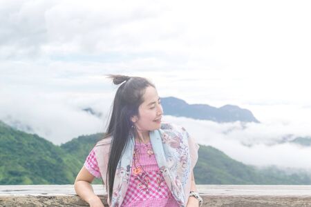 Women sitting in natural scenery mountain backgroundの写真素材