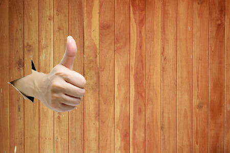 Hand thumb and like on a wall backgroundの写真素材