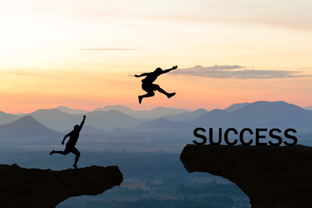 Men jump over silhouette failure commitment to successの写真素材