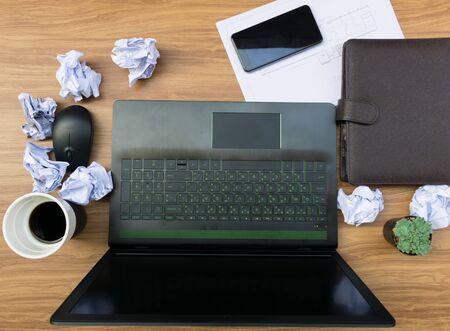 Business mistake on the desk Working document paper Laptops Computer Notebook and Coffeeの写真素材