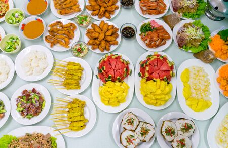 Food Variety Table top Fried chicken Fried fish roasted pork papaya salad roasted duck and fruit Orange watermelonの写真素材