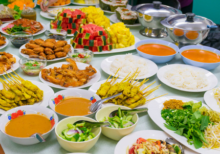 Food Variety Table top Fried chicken Fried fish roasted pork papaya salad roasted duck and fruit Orange watermelonの写真素材
