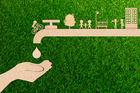 Droplet tap live water save ecology concept of paper cut tree green grass.の写真素材