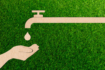 Droplet tap live water save ecology concept of paper cut tree green grass.の写真素材