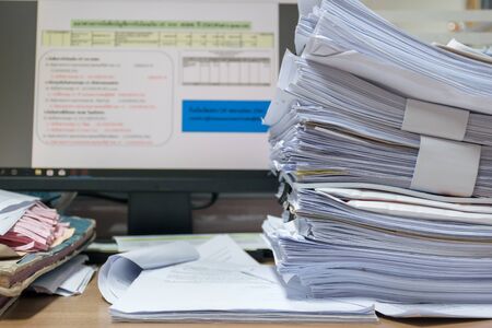 lot of work document paper on the desk office