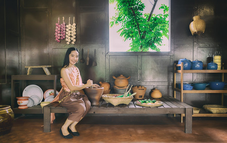 Lady Thailand wearing Thai traditional clothes make foodの写真素材