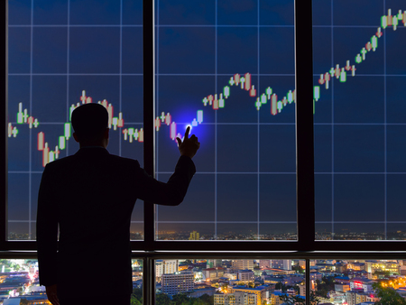 Businessmen touch screen stock exchanges and financials.