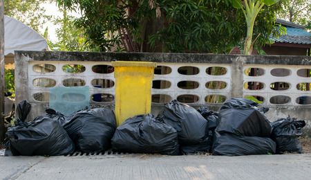 Black garbage bags And yellow a trashの写真素材