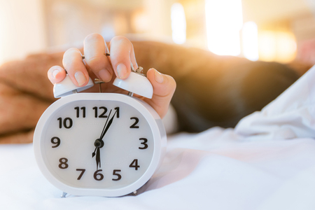 Alarm clock that wakes up in the morning in the bedroomの写真素材