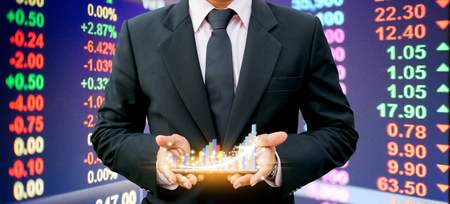 Businessmen holding bar graph on the smartphone Investment technology financeの写真素材