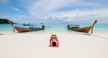 Women lie on the beach and the sea have a holiday summer relaxing and travel bright sky koh lipe thailandの写真素材
