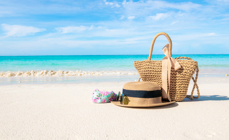 Hats and glasses placed on the beach and sea have a holiday summer relaxing and travel bright sky koh lipe thailandの写真素材