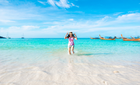 Happy woman running the beach and sea have a holiday summer relaxing and travel bright sky koh lipe thailandの写真素材