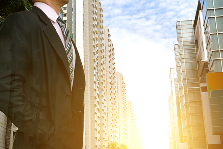 businessman leadership wearing in a city with buildings looking at city skyline at sunset the concept of modern life businessの写真素材