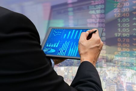 Technology business touch screen tablet stock market graph viewingの写真素材
