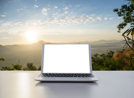 Notebook Laptop in the office The background nature and mountainsの写真素材