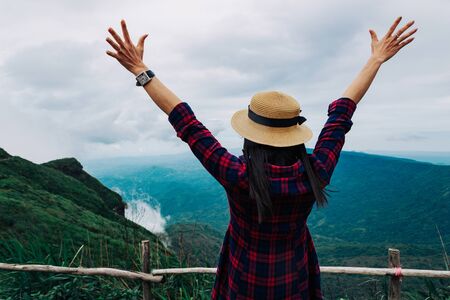 Woman travel rainy season mountain view relax in the holidayの写真素材