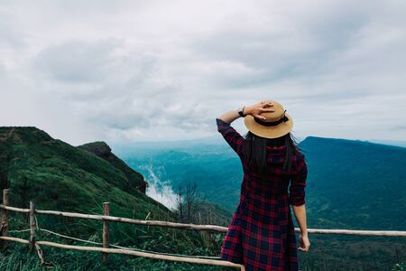Woman travel rainy season mountain view relax in the holidayの写真素材