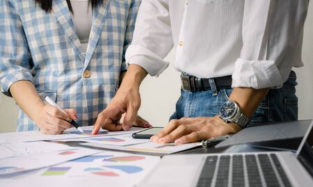 Working business team graph analysis on the desk