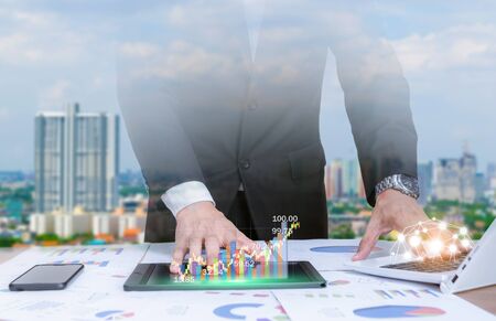 Double exposure businessman analyze graphs with computers, smartphones and tablet technology social...