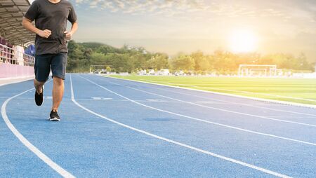 Men runners jogging for health on the fieldの写真素材