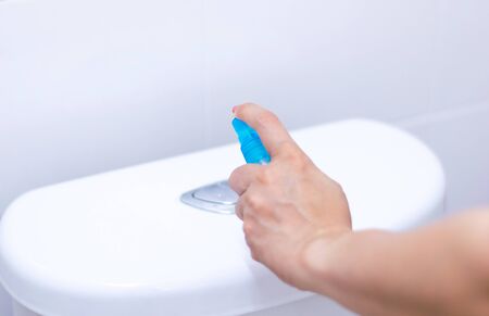 Alcohol spray press flush toilet clean protection against Coronavirus 2019 (Covid-19)の写真素材