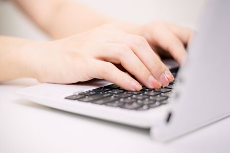 Woman hand pressing computer keyboard concept Business working in an office or Work at homeの写真素材