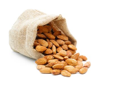 Almonds in a sack of cloth on a white backgroundの写真素材