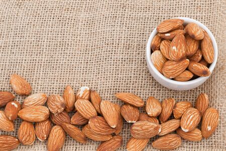 Almonds In a cup on fabric sacks   の写真素材