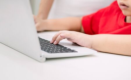 Adults teach children use computer the educationの写真素材