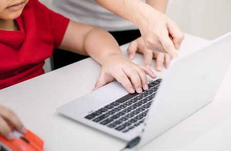 Adults teach children use computer the educationの写真素材