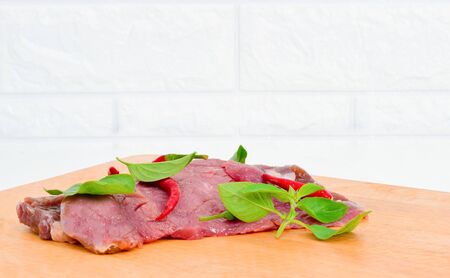 Fresh chili meat on a wooden cutting boardの写真素材