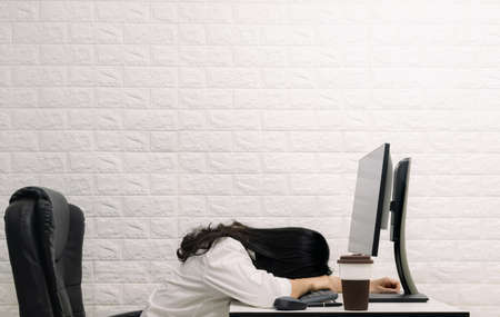 A woman sleeping on the desk Computer screenの写真素材