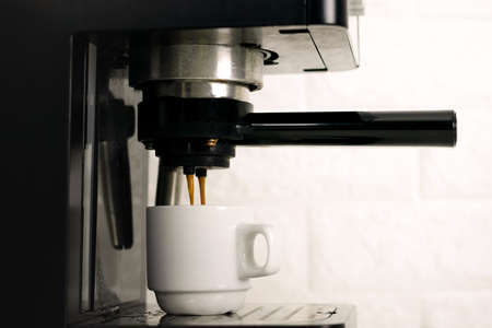 Coffee machine extraction into a coffee cupの写真素材