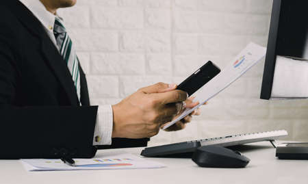 business men analyze graphs and check sales growth.の写真素材