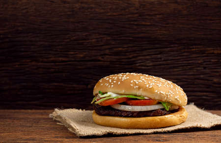 Hamburger meat and vegetables on wooden backgroundの写真素材